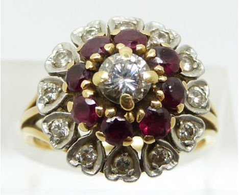 An 18ct gold ring set with a round brilliant cut diamond of approximately 0.45ct surrounded by rubies and further diamonds (s