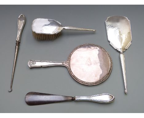 Hallmarked silver mounted hand mirror and matching brush, hallmarked silver handled button hook and shoe horn and a white met