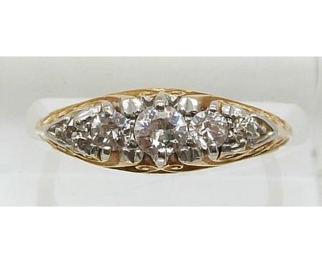 An 18ct gold ring set with five diamonds, the centre diamond approximately 0.2ct (size J)