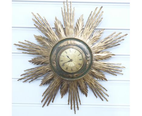A retro 1960/70s sunburst clock, brass Roman dial with central engine turned decoration, 42cm diameter&nbsp;