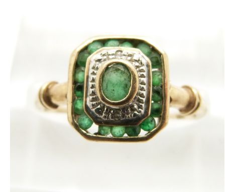 A 9ct gold ring set with emeralds and diamonds in an Art Deco style, in original box (size K/L)