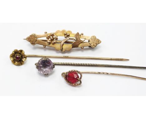 A 9ct gold brooch, silver stick pin set with an amethyst and two other stick pins