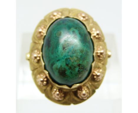 A 14k gold ring set with an azurite cabochon, with textured detail to the setting, marked W9H,&nbsp; size L