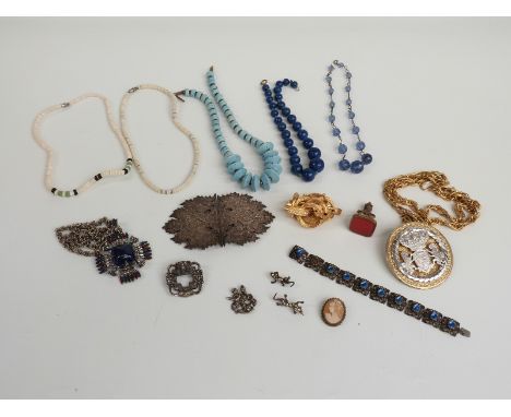 A collection of jewellery to include a white metal buckle, glass beads, ceramic beads, Les Bernard pendant, Castlecliff penda