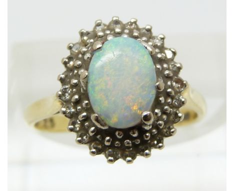 An 18ct gold ring set with an opal and diamonds (size K/L)