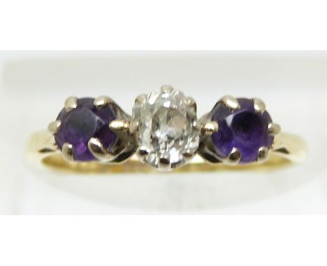 An 18ct gold ring set with an old cut diamond of approximately 0.3ct and two amethysts (size K)
