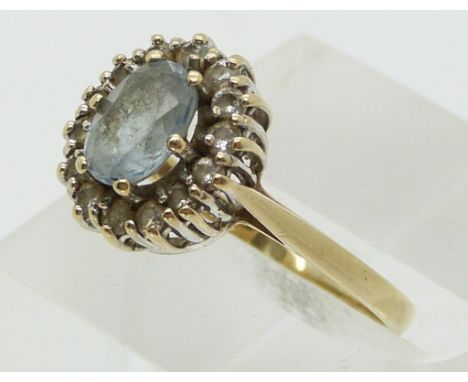 A 9ct gold ring set with an aquamarine and cubic zirconia&nbsp; (size M)