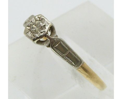 An 18ct gold ring set with a diamond in a platinum setting (size L)