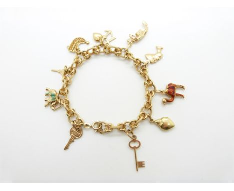 An 18ct gold bracelet with ten 18ct gold charms including an enamel camel and elephant by Fabor, 26.6g&nbsp;