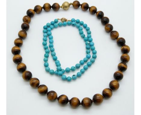 A single strand of tigers eye with a silver gilt clasp and a single strand of turquoise with a 9ct gold clasp&nbsp;