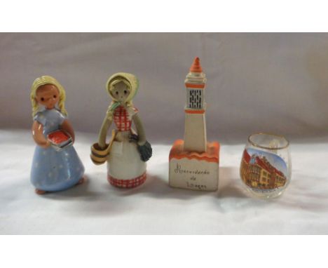Two Finnish Pottery figurines, depicting ladies - sold with a French pottery lighthouse souvenir and a small German souvenir 