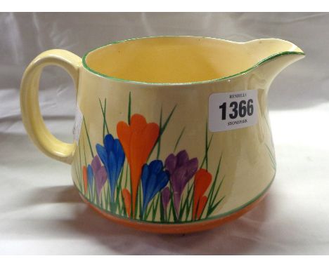 A Clarice Cliff Bizarre pottery jug with hand painted 'Crocus' decoration on a honeyglaze ground