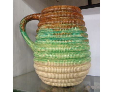 A Clarice Cliff 'Bizarre' pattern decorated calico jug with painted finish