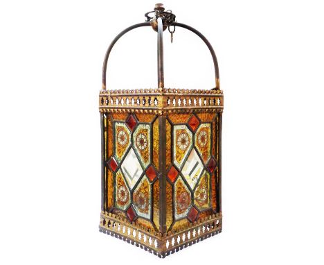 A late 19th Century Aesthetic Movement hall lantern of brass caged rectangular form, with four stained and painted glass pane
