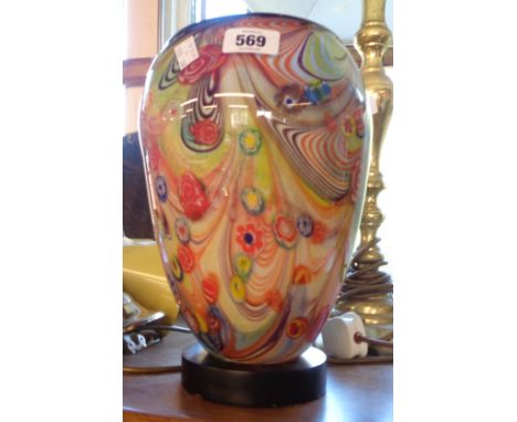 A glass table lamp with millefiori light up body set on wooden base