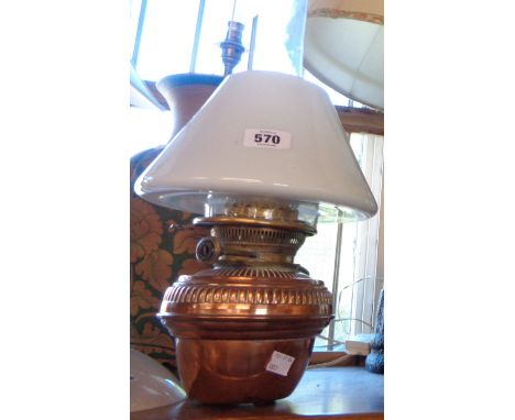 A copper oil lamp with brass fittings and Hinks and Sons burner, glass chimney and opaque shade