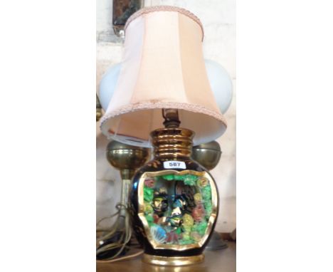A vintage French pottery table lamp of hollow form with moulded aquarium scene - sold with shade - a/f