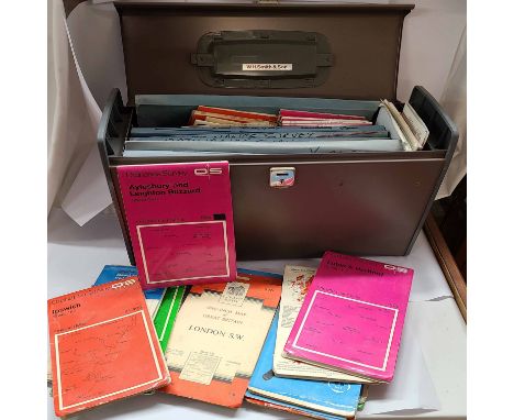 A metal file box containing a collection of Ordnance Survey folding maps