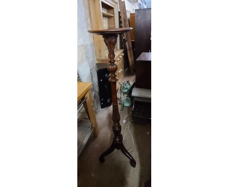 A 19th Century stained mahogany torchere with carved and turned pillar, set on tripod base