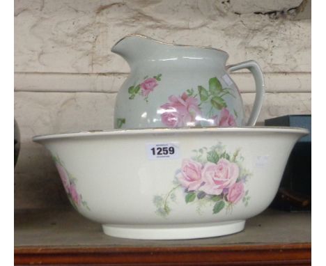 An early 20th Century Grimwades pottery toilet jug with transfer printed rose decoration - sold with an associated bowl