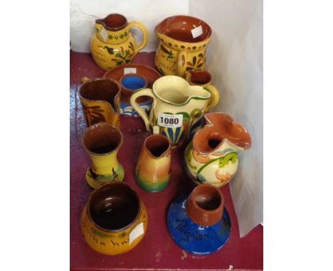 A quantity of Torquay Pottery including jugs, vases, match striker, etc. - various decoration including scandy, motto, etc. -