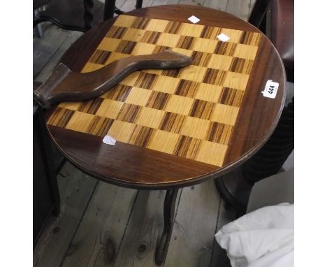 A 46cm diameter modern mixed wood pedestal games table, set on turned pillar and tripod base - sold with plastic chess pieces