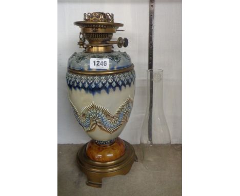A 19th Century Doulton Lambeth oil lamp with lift-out ceramic set glass reservoir, the body set on brass trefoil basem, with 