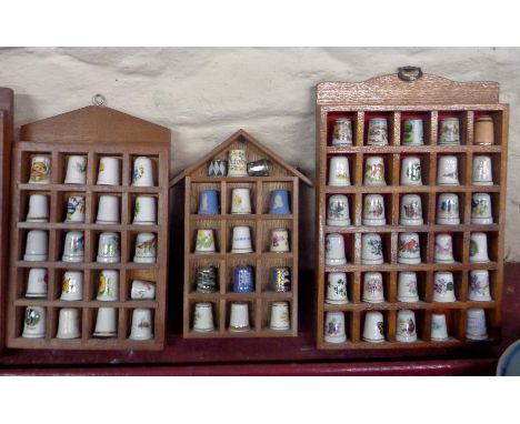 A large quantity of ceramic and other collectable thimbles including cloisonne, Jasperware and other examples, set in five wo