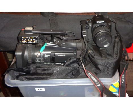 A crate containing a Canon EOS 1300D DSLR camera with Canon zoom lens, a Panasonic HD camcorder in a carry case and a tripod