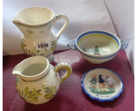 Four pieces of Henriot Quimper pottery comprising two jugs, a two handled bowl and a small dish