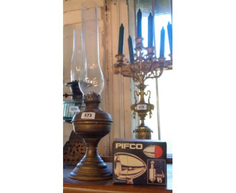 A brass oil lamp with glass chimney - sold with an unused vintage Pifco bicycle dynamo lighting set, in original box