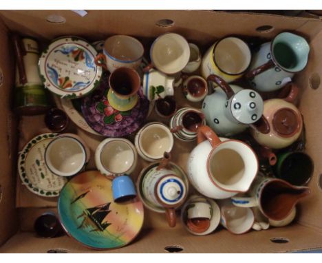 A box containing a quantity of Torquay pottery including jugs, vases, teapot stands, plates, etc. - various decoration includ