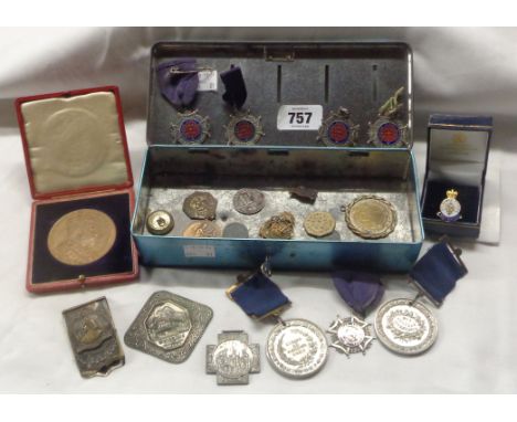 A vintage thrift box tin money box containing a quantity of medallions and tokens including cased 1902 coronation medallion, 