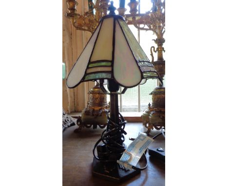 A table lamp with Tiffany style shade