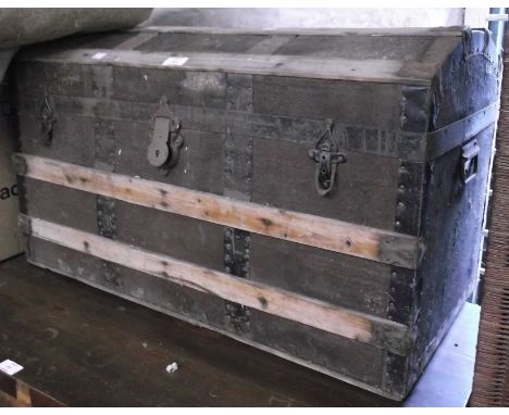 An 82cm Victorian dome-top travelling trunk with wood and iron binding over canvas weather coating - tray missing