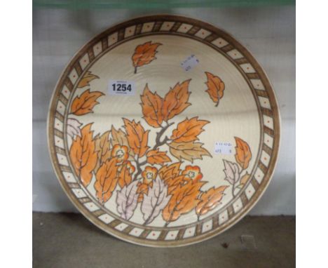 An Art Deco Crown Ducal Charlotte Rhead pottery charger with tube lined decoration depicting autumn leaves