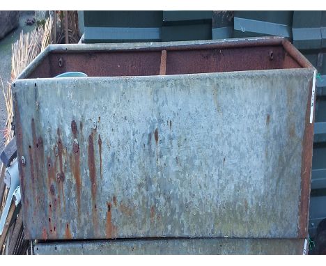A large galvanised metal water trough