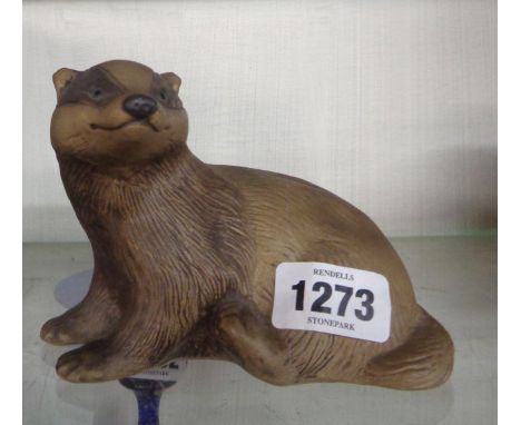 A Poole Pottery figurine, depicting a badger with brown and painted glazed finish, from a design by Barbara Linley-Adams