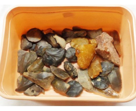 A tub containing a quantity of Neolithic flint tools including arrow heads, scrapers, etc.