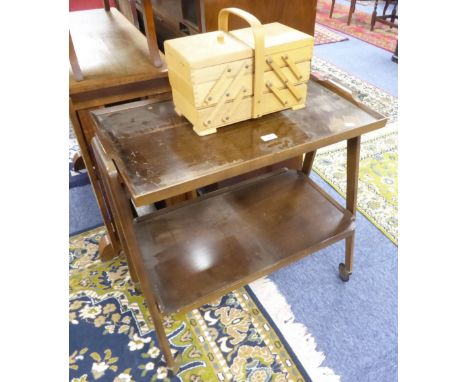 A LIGHT WOOD CANTILEVER SEWING BOX; A WOODEN TWO TIER TEA TROLLEY, 1970S STYLE AND A TEAK TWO TIER LONG, OBLONG COFFEE TABLE 