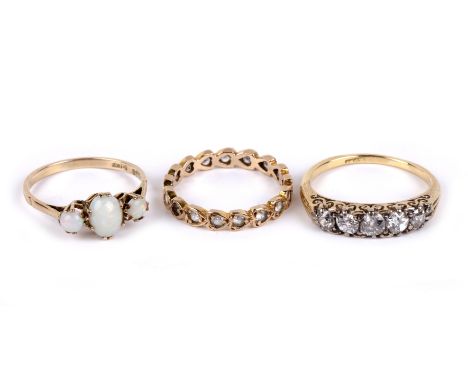 Group of three rings comprising 9ct gold three stone opal ring, a yellow metal five stone diamond ring, stamped '18ct' to the