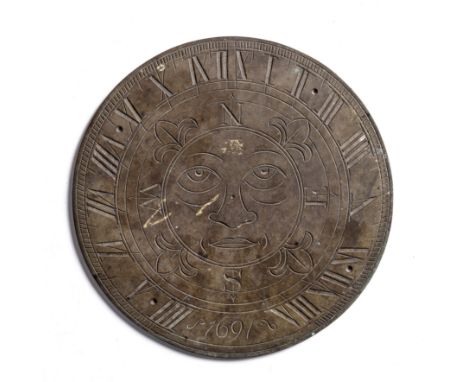 Bronze sundial engraved with a green man to the centre and Roman numerals to the border, dated 1691, 25.5cm approx overallPro