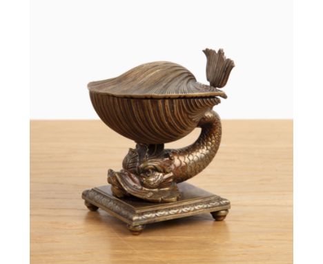 Bronze inkwell Regency, in the form of a shell resting upon a stylised scaled fish, on a square form plinth with bun feet, ma