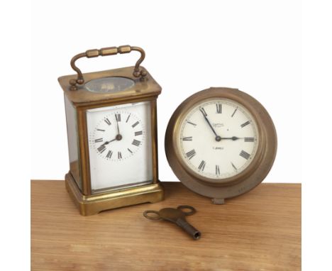 Two clocks one a Swiss brass cased carriage clock, the white enamel dial with black Roman numerals, 13cm high approx overall 