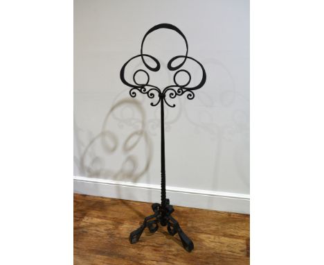 Wrought iron music standof scrolling form, with a triform base, 140cm highProvenance: The property of a Gentleman, from a per