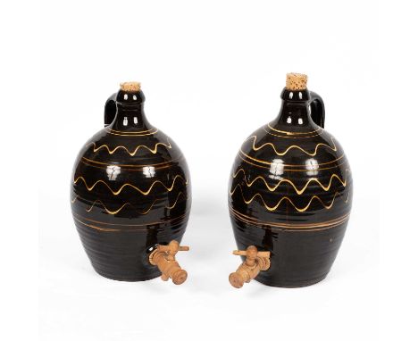 Winchcombe Pottery: two cider flagons with wavy line decoration, wooden tap and cork stopper, each 34cm highOverall good cond