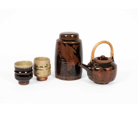 ARR Phil Rogers (1951-2020) a tenmoku glazed teapot with cane handle, 21cm high (including handle), a tenmoku glazed jar and 