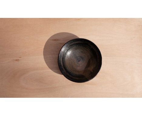 ARR William Marshall (1923-2007) a stoneware shallow dish in tenmoku glaze decorated incised lines to rim, impressed seal to 
