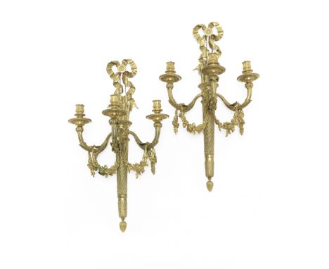 A pair of gilt bronze three-light wall appliques in the Louis XVI style,each cast with quiver and arrows, floral and ribbon s