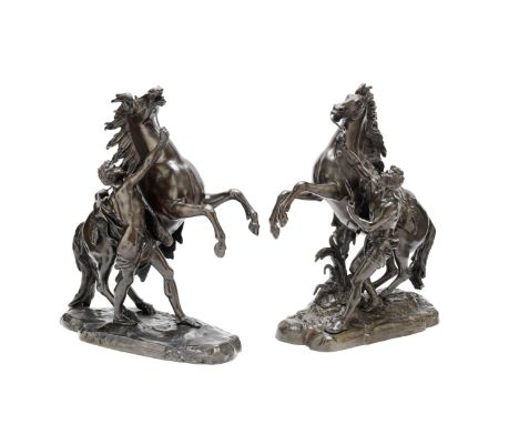 AFTER GUILLAUME COUSTOU (FRENCH, 1677-1746): A PAIR OF BRONZE MODELS OF THE 'MARLEY HORSES',dark brown patina 58cm cm high 22